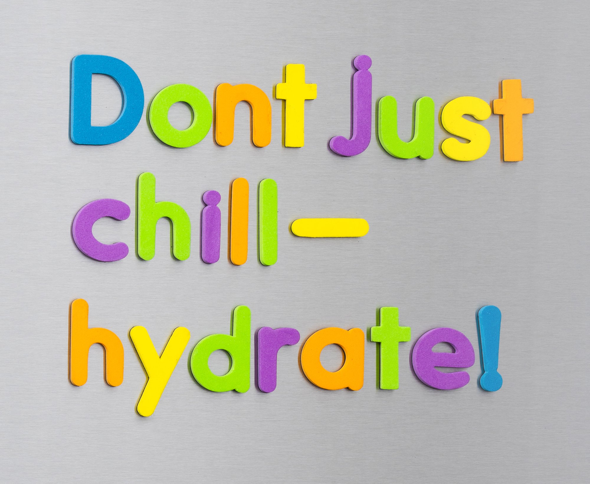 Don't Just Chill – Hydrate! written in magnetic letters on a fridge door
